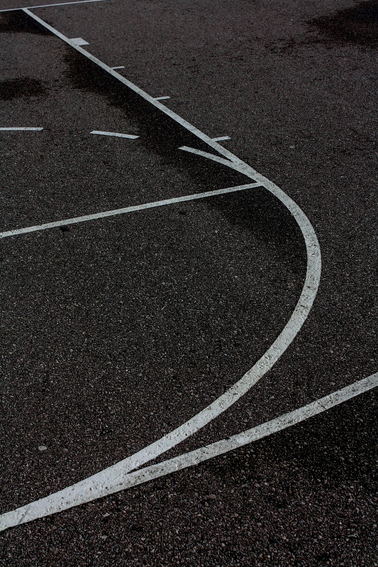 Illustrative outdoor basketball court at night